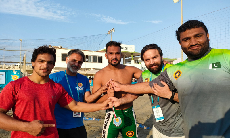 Inam Butt (middle) after winning gold medal at the World Beach wrestling held in Italy