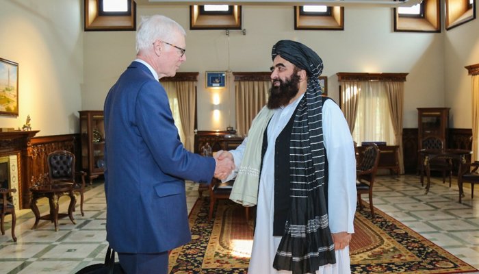 UK envoy shaking hands with Minister of Foreign Affairs Amir Khan Muttaqi