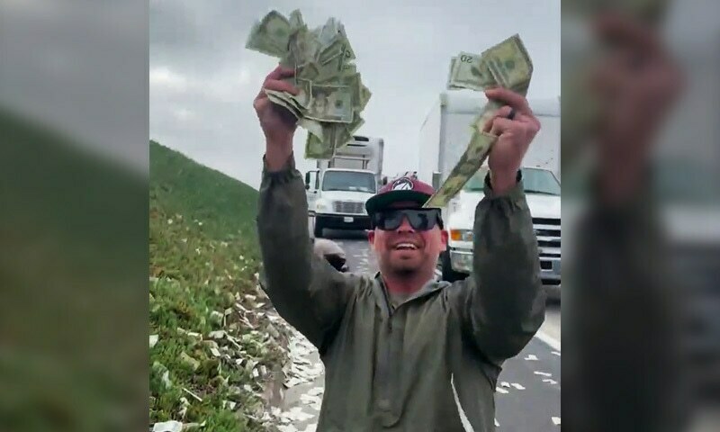 A man collecting bank notes spilled from an armored cash truck on California freeway