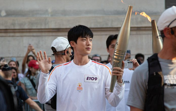 BTS’ Jin Carries Olympic Torch in Paris For 2024 Olympic